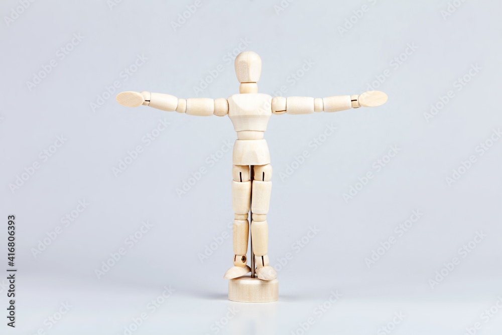 Wooden figurine, small painting mannequin figure model, man with his arms spread wide, power pose, human body language and personal space proxemics scientific cultural research abstract concept Wooden figurine, small painting mannequin figure model, man with his arms spread wide, power pose, human body language and personal space proxemics scientific cultural research abstract concept