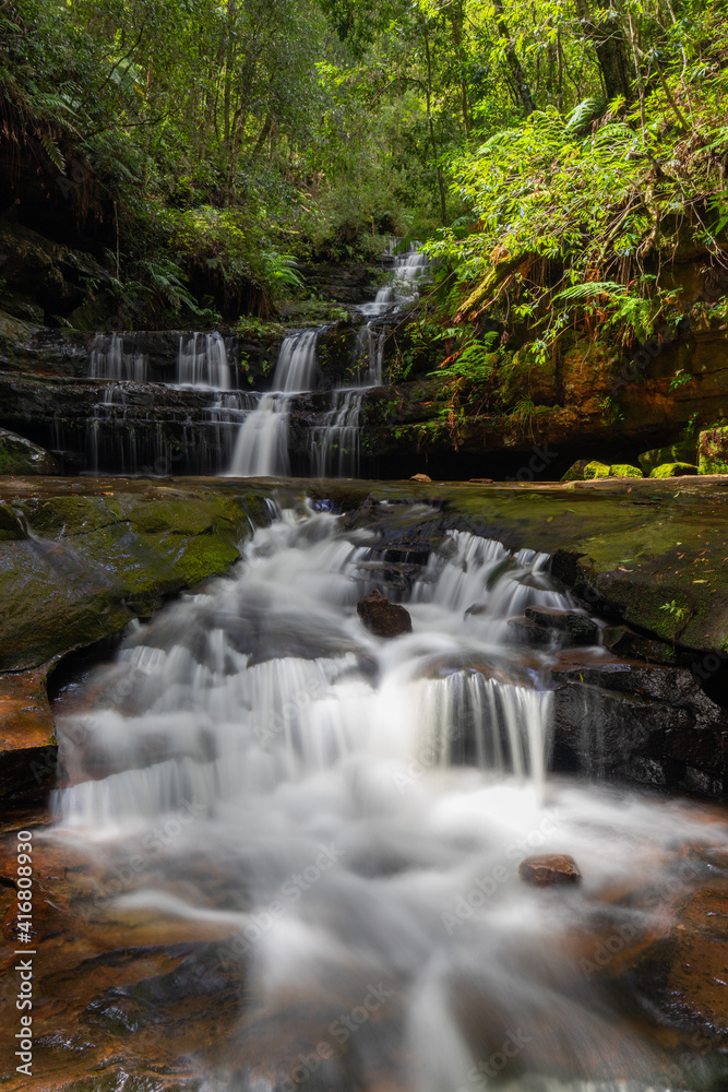 Water flowing through multi-level waterfalls.