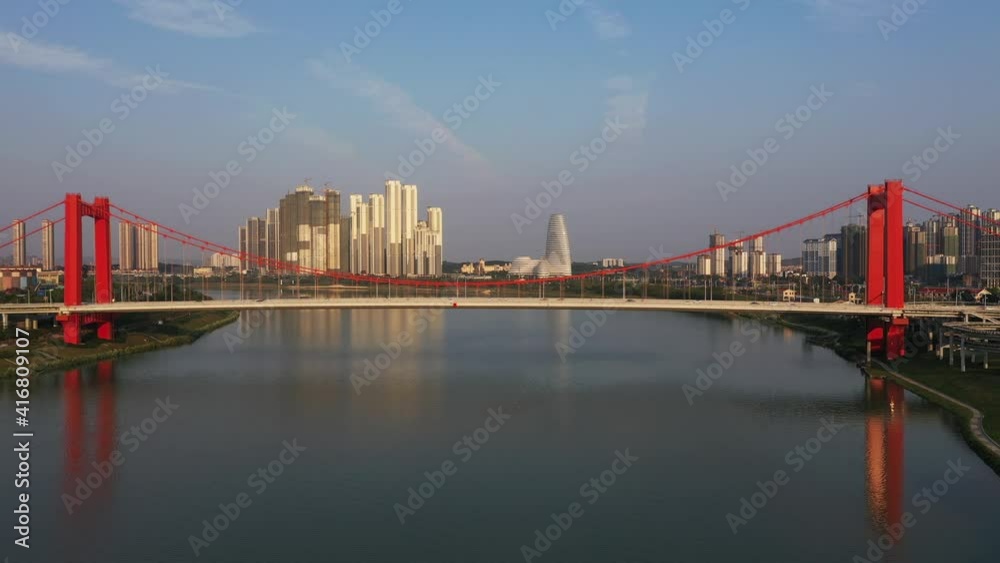 Drone view of urban cross-river red steel cable-stayed bridge and traffic view in China Drone view of urban cross-river red steel cable-stayed bridge and traffic view in China