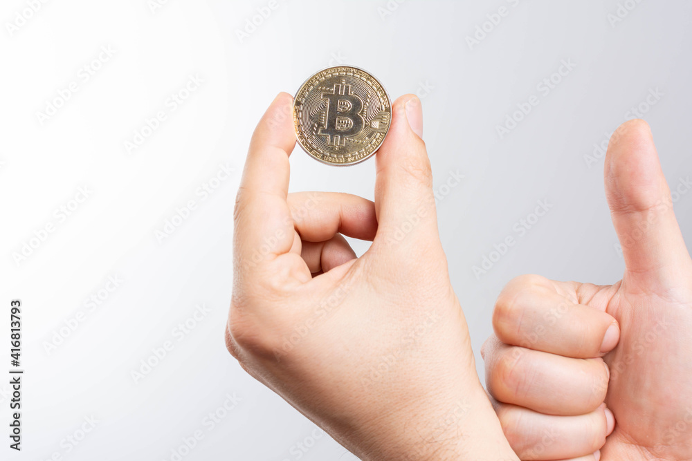 On a white background we look at a virtual currency, namely the cryptocurrency bitcoin, held in the right mine. On a white background we look at a virtual currency, namely the cryptocurrency bitcoin, held in the right mine.
