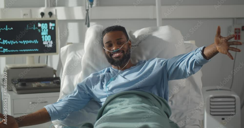 Sick african man lying in hospital bed welcoming and hugging little daughter visiting Sick african man lying in hospital bed welcoming and hugging little daughter visiting