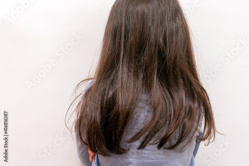 Photography A small child with long brown hair turned away from the camera