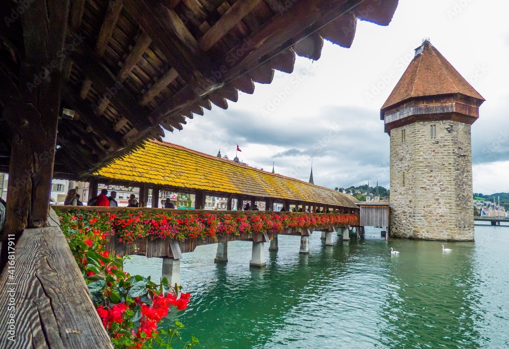 Kapellbrücke, un puente de madera rícamente decorado, y su torre de la capilla, con la orilla norte del río Reuss en Lucerna (Suiza)