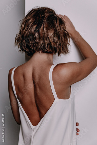 Girl in a nightie with a tanned bare back