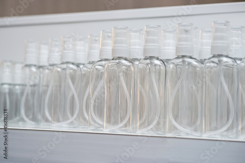 spray bottles for various cosmetic liquids on a white background