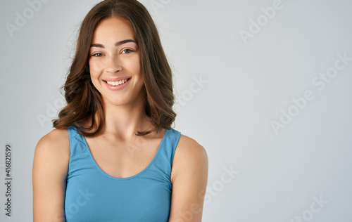 woman in blue t-shirt attractive happy mood gray background