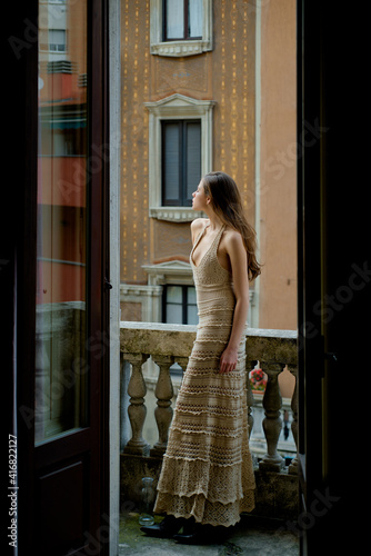 Woman on balcony. City girl portrait. Fashion and beauty. Luxury street style. © Volodymyr