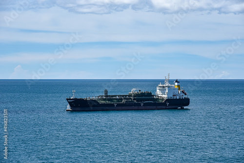 Tanker ship sailing through calm  blue ocean.