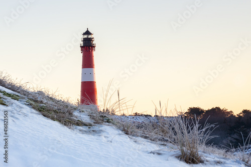 Leuchtturm Hörnum an einem verschneiten Wintermorgen zur goldenen Stunde