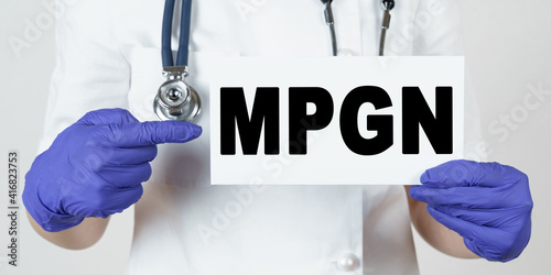 The doctor points his finger at a sign that says - MPGN. membrane proliferative glomerulonephritis photo