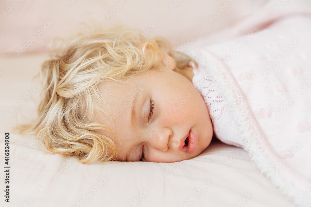 Baby girl sleeping under pink blanket. Baby girl sleeping under pink blanket.