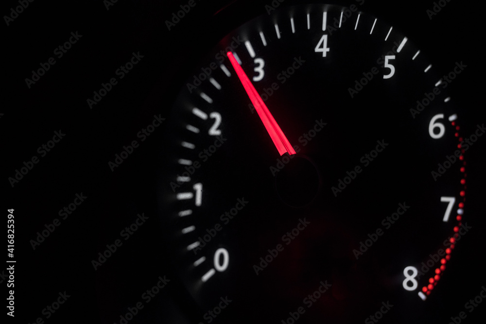 Car tachometer on a black background. traffic, gas, race. Engine speed