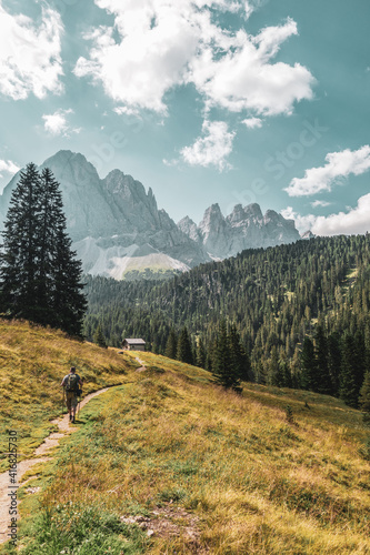 Mountain hikers in the Dolomites, Italy. Odle mountain peaks.