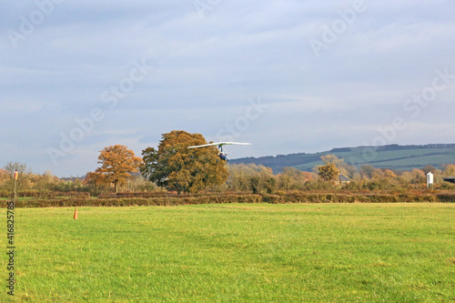 Valokuva Ultralight airplane landing on a grass strip