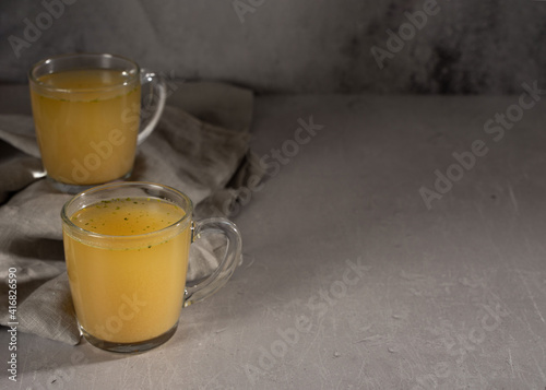 hot homemade chicken broth with collagen and amino acids in a transparent glass cup