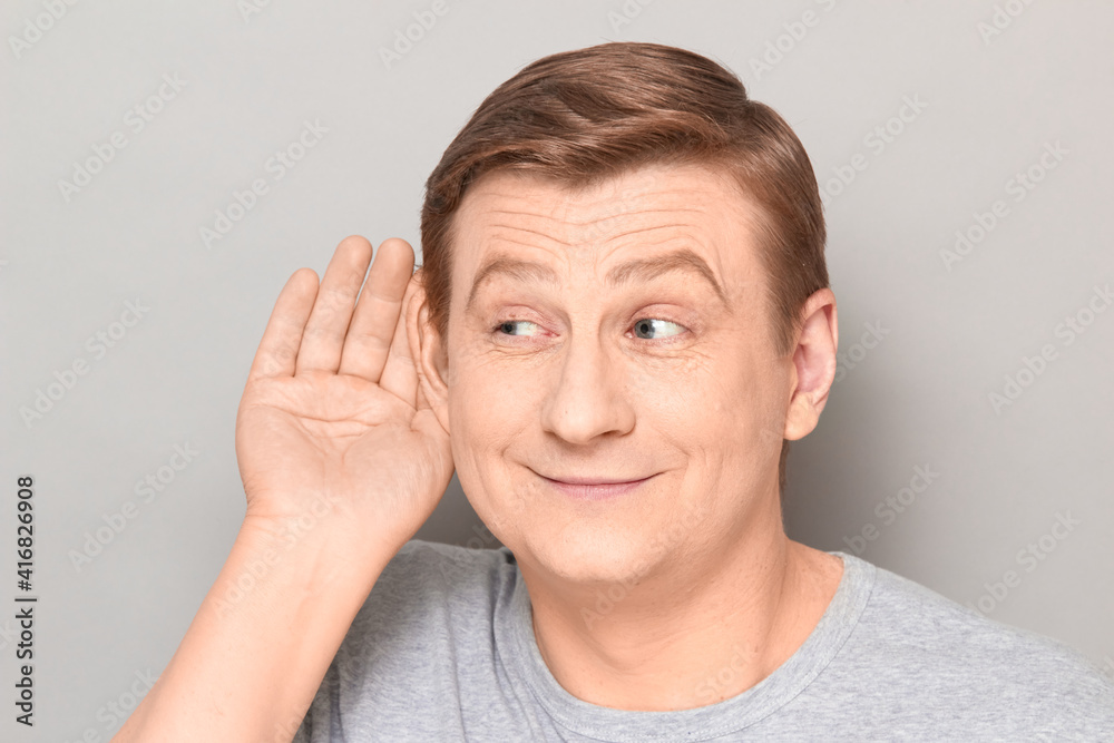 Portrait of happy man placing hand near ear and eavesdropping Portrait of happy man placing hand near ear and eavesdropping