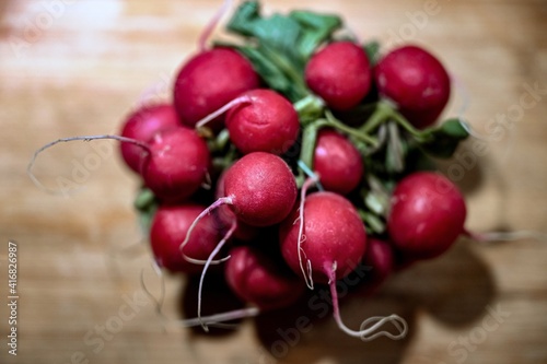 Red radishes on the bunch on a cutting board