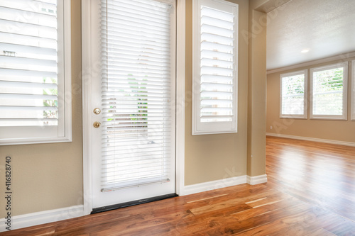 Bright beige large empty room with wood floor  molding and windows. Modern bright room  interiors.