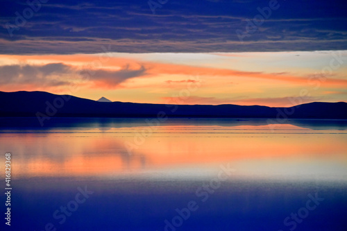 Reflection of mountain and clouds on the salt flat covered with water at dawn, Salar de Uyuni, Potosi Department, Bolivia