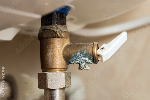 Fotografie Ceramic deposits on the water heater boiler cleaning prevention close-up
