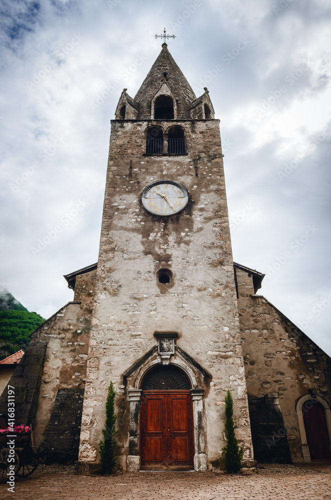 Exterior view of the Eglise du Cloitre, ancient medieval gothic church near the castle of Aigle, small winemaking village in the Vaud region of the swiss alps, switzerland. Detail of the bell tower