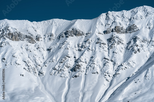 Caucasus mountains. Abishir-Ahuba ridge (Dinnik peak). View from the Northern slope of the Arkhyz ski resort. Snow-white mountainside. Winter mountain landscape. Background, wallpaper.