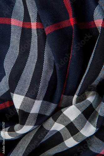 top view flat lay closeup part of folded dark blue checked scarf