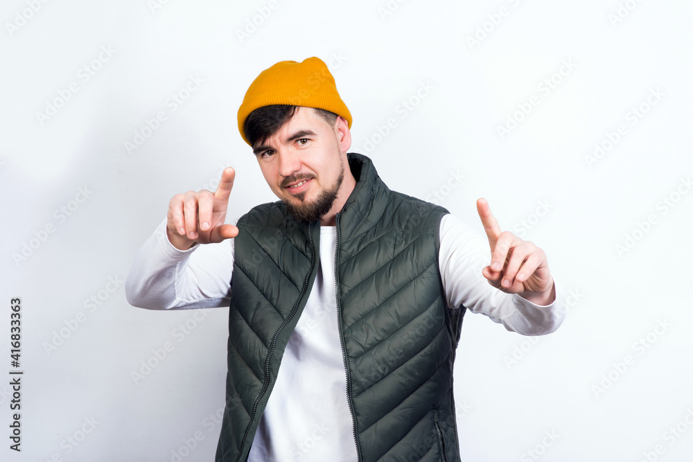 young handsome man - in stylish vest and white t-shirt thumbs up smiling young handsome man - in stylish vest and white t-shirt thumbs up smiling