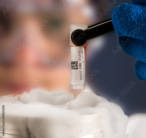 Medical lab technician working with a test tube in a cryogenic laboratory photo