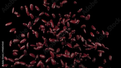 Flying red beans on a black background. Red beans. Super slow motion.