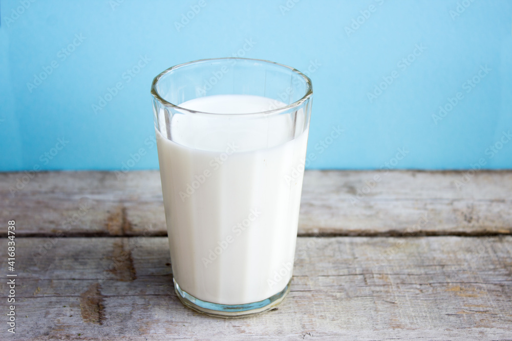 Milk in a glass on a wooden table. Fresh milk Milk in a glass on a wooden table. Fresh milk