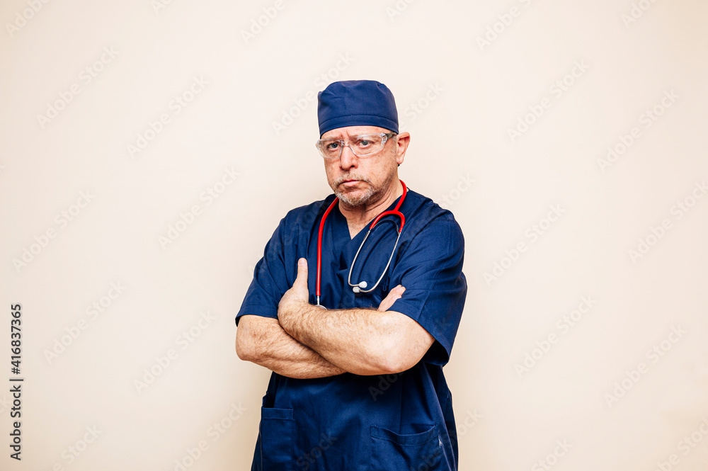 Studio portrait of a veteran doctor in an operating room suit Studio portrait of a veteran doctor in an operating room suit