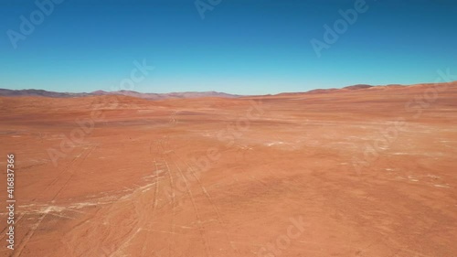 Exploring Atacama Desert vast dry extensions in the driest area of this amazing desert with an all terrain vehicle. An awe road trip adventure crossing the infinite sand extensions from an aerial view