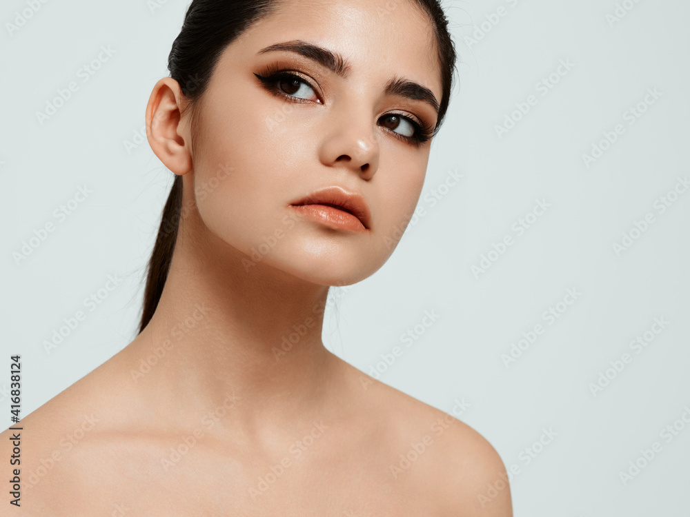woman with dark hair on a light background naked shoulders cosmetology spa salon skin care woman with dark hair on a light background naked shoulders cosmetology spa salon skin care