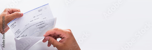Businessman opening envelope with paycheck