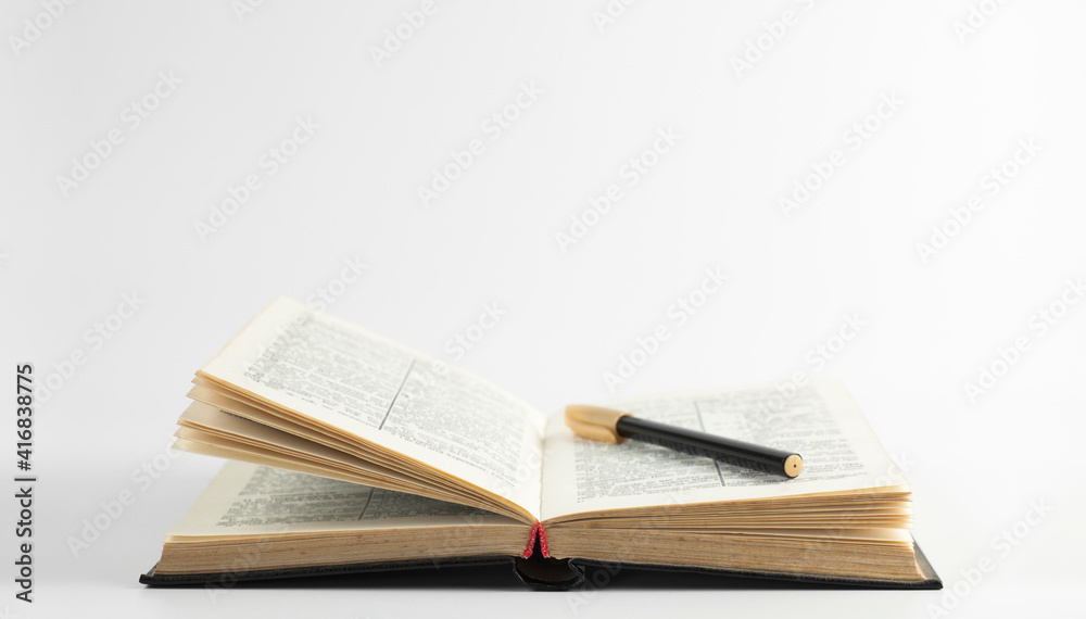Open holy bible book on the table. Scripture. A pen Open holy bible book on the table. Scripture. A pen