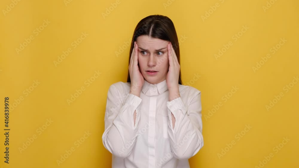 Portrait of sick ill young female 20s put hands on head rub temples suffering from headache migraine feel bad seedy, dressed in white shirt, isolated on yellow studio background with copy space. Portrait of sick ill young female 20s put hands on head rub temples suffering from headache migraine feel bad seedy, dressed in white shirt, isolated on yellow studio background with copy space.