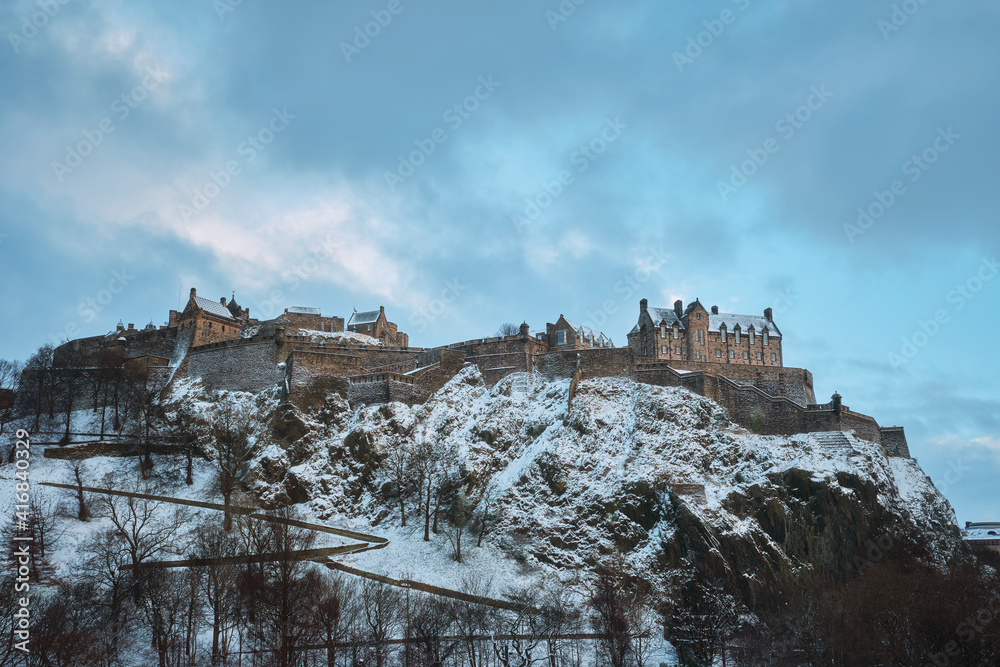 Old Scottish castle on a rock covered with snow in winter. View of Edinburgh Castle, Edinburgh, Scotland, United Kingdom