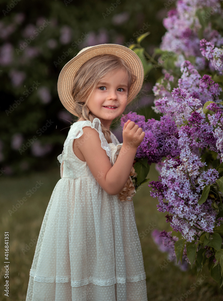 little girl in a straw hat holding a bouquet of lilacs. Girl with flower. Девочка с цветами little girl in a straw hat holding a bouquet of lilacs. Girl with flower. Девочка с цветами