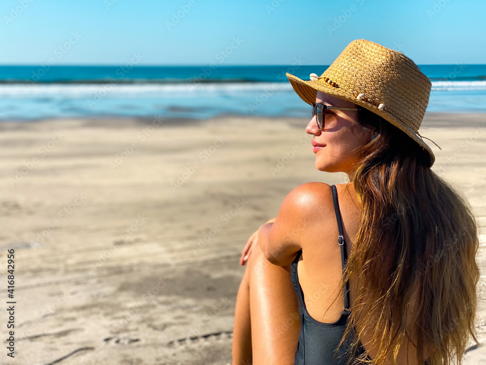 Closeup Of A Young Woman At The Beach With A White Hat