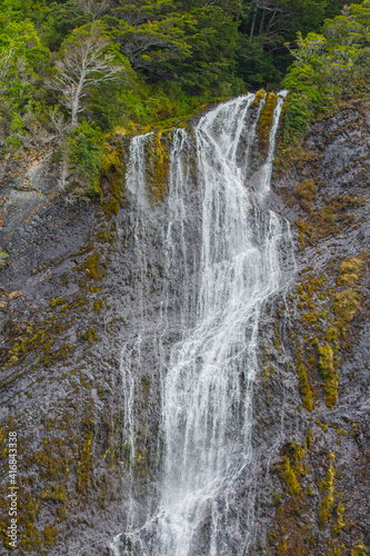 Cascading down dramatic granite cliffs, this waterfall pours into the Baker Channel in the Parc Nacional Bernardo O'Higgins in Chile.