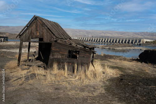 The Columbia River and The Dalles Dam and historic Indian salmon fishing shacks in The Dalles, Oregon photo