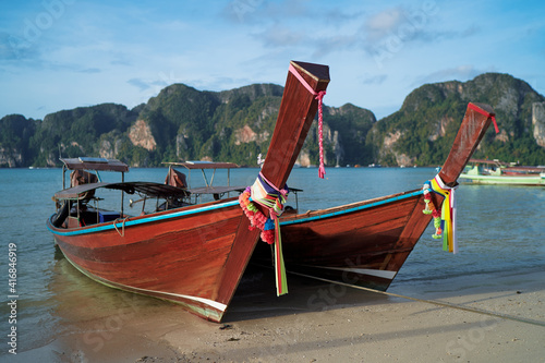 Travel by Thailand. Landscape with traditional longtail fishing and tourists boat on the sea beach.