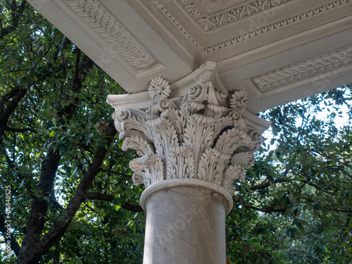 Corinthian capital decorated with acanthus leaves and scrolls photo