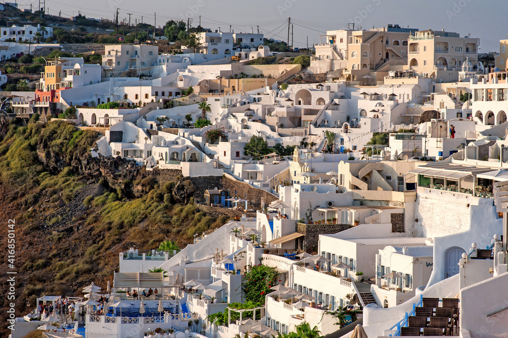 Fira, modern capital of the Greek Aegean island, Santorini. Santorini is iconic travel destination in Greece, famous of its sunsets and traditional white and blue architecture.