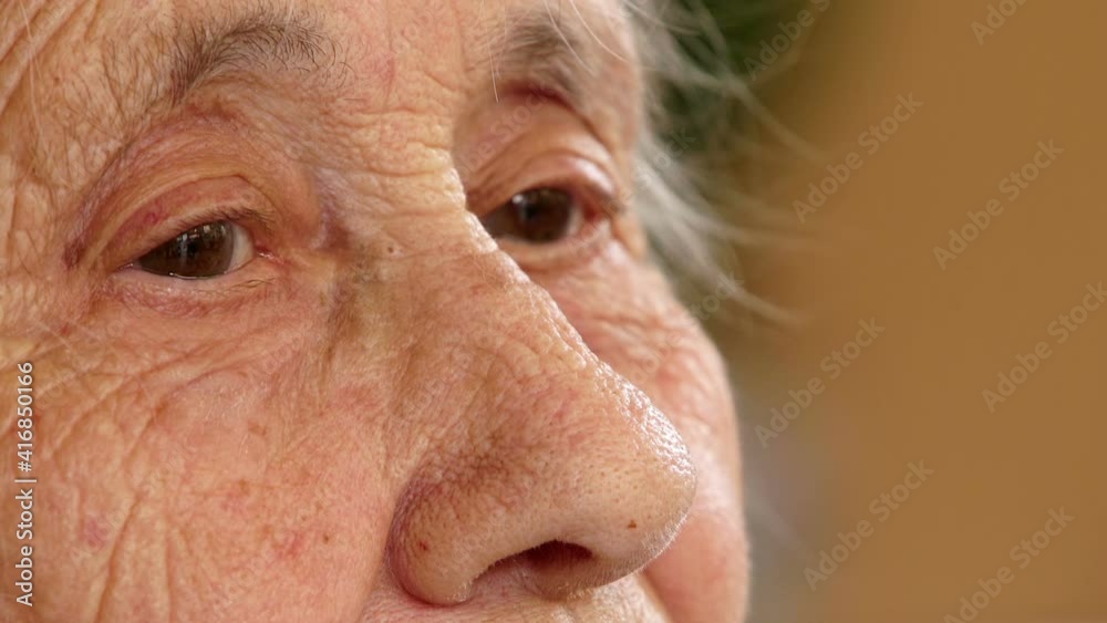 sad pensive elderly woman looks away lost in her memories - macro sad pensive elderly woman looks away lost in her memories - macro