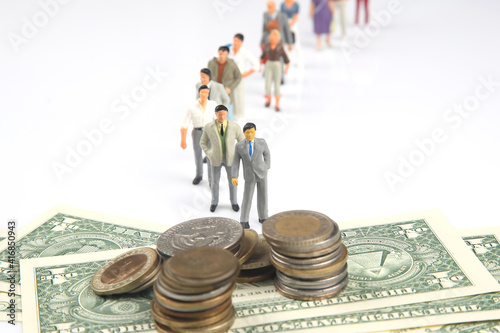 miniature people. people are queuing up to get paid. investments and earnings for work