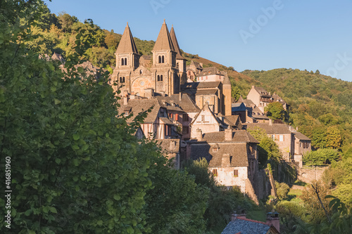 The quaint and charming medieval French village of Conques  Aveyron  and Abbey Church of Sainte-Foy  a popular summer tourist destination in the Occitanie region of France.