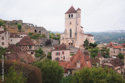 Canvas Print The French medieval hilltop village of Saint-Cirq-Lapopie and its 16th century fortified church in the Lot Valley, France