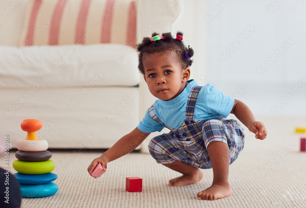 cute african american baby girl playing toys at home Stock Foto Adobe Stock